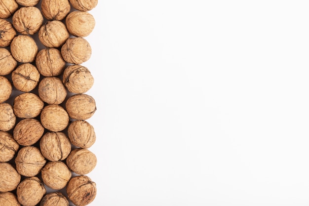 Flat lay of hard shell walnuts with copy space