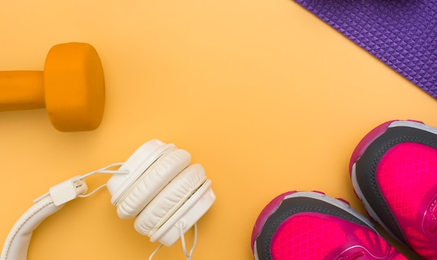 Flat lay of headphones with weight and sneakers