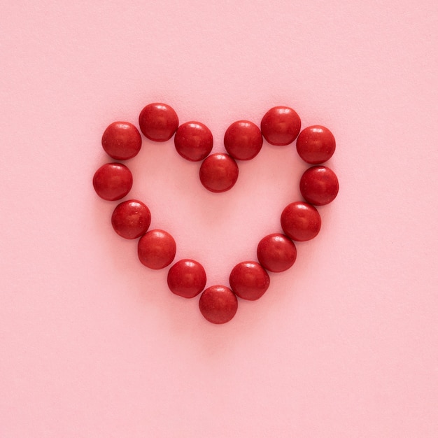 Flat lay heart shape candy arrangement