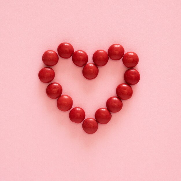 Flat lay heart shape candy arrangement