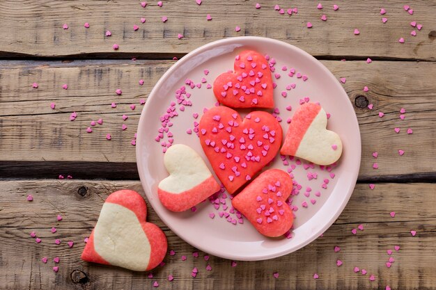 Flat lay of heart-shaped cookies on plate