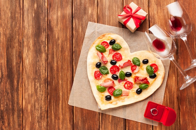 Flat lay heart shaped pizza with ring