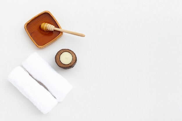 Flat lay of honey and cloth on plain background