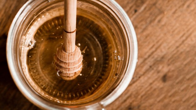 Flat lay honey jar on wooden table