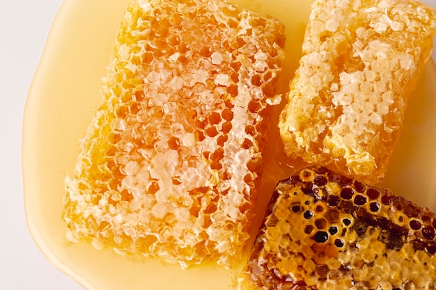 Flat lay honeycombs on honey