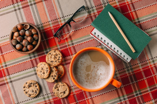 Flat lay of hot chocholate and cookies on cashmere background