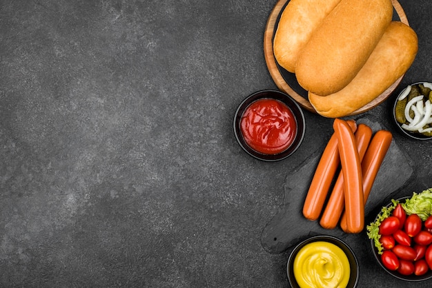 Free photo flat lay hot dog ingredients with copy-space