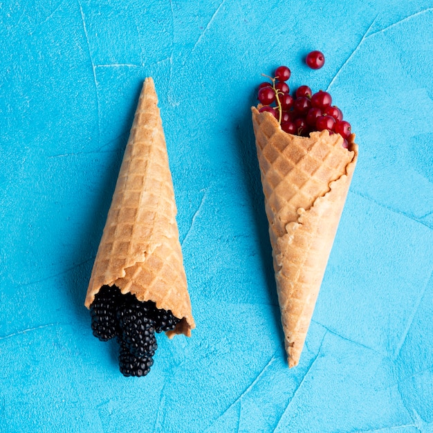 Flat-lay ice cream cones with berries