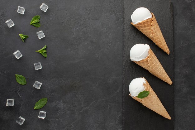 Flat lay ice cream on cones with ice cubes