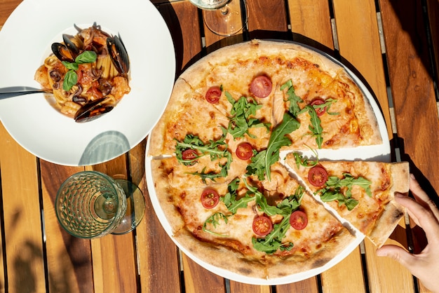 Flat lay of italian food on wooden background