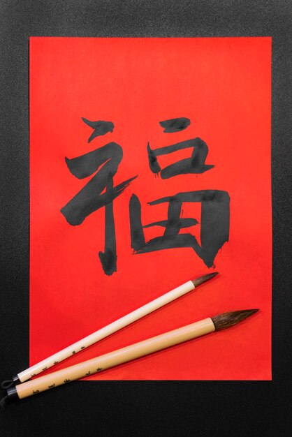 Flat lay japanese symbols with brushes