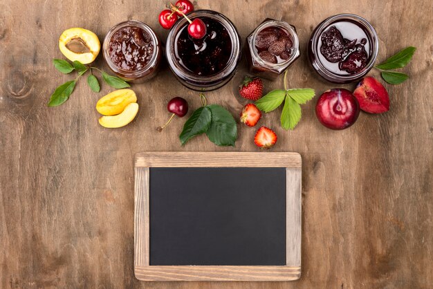 Free photo flat lay jars with stewed fruit