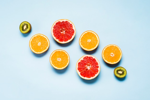 Flat lay of juicy oranges, grapefruits and kiwis