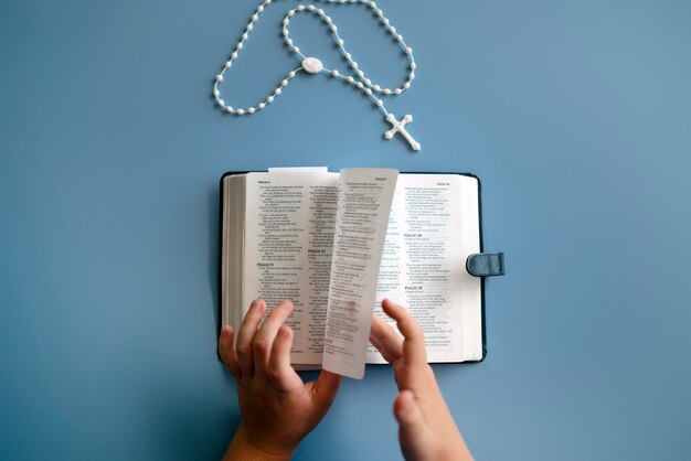 Flat lay kid holding bible