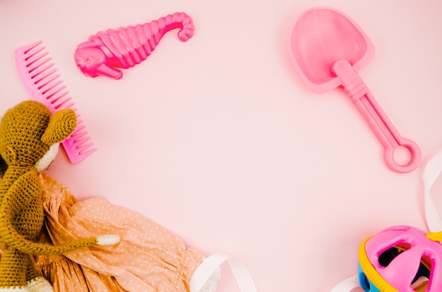 Flat lay kids toys with pink background