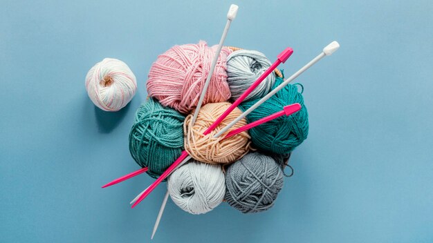 Flat lay knitting needles and wool in basket