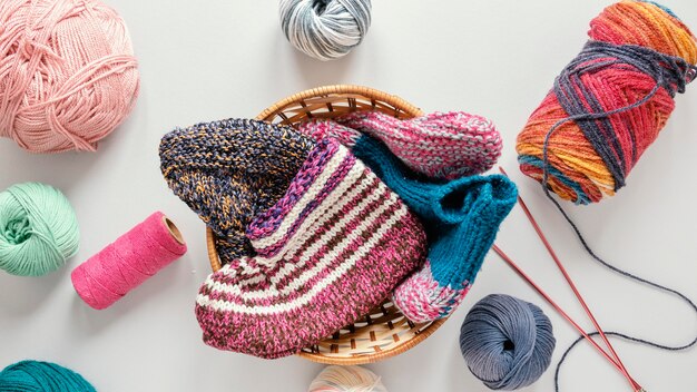 Flat lay knitting needles and wool in basket