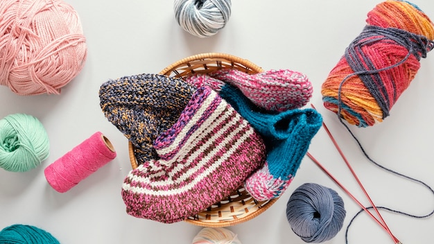 Flat lay knitting needles and wool in basket