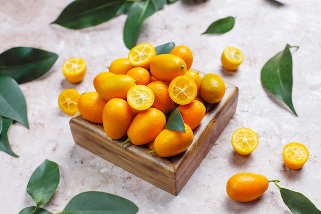 Flat lay of kumquats on a concrete surface