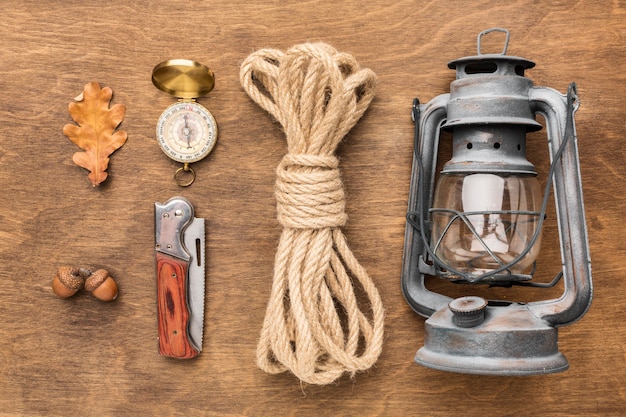 Flat lay of lantern with rope and autumn leaves