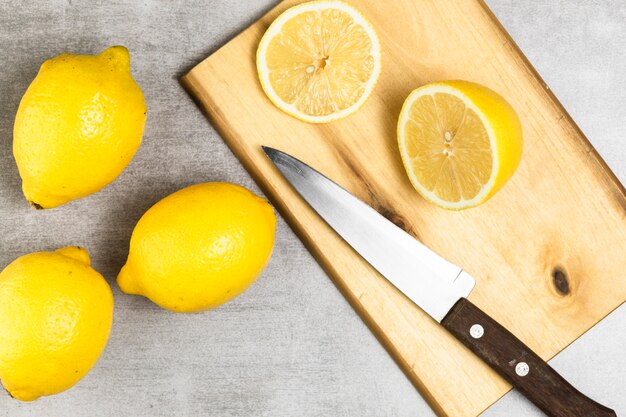 Flat lay of lemons on chopper and wooden table