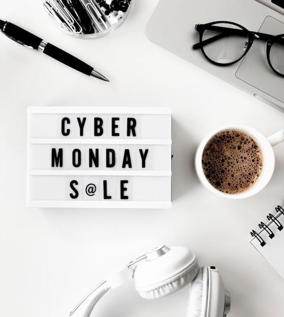 Flat lay of light box for cyber monday with laptop and coffee