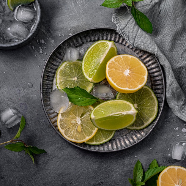 Flat lay lime and lemon slices on plate