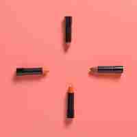 Free photo flat lay of lipsticks on plain bakground