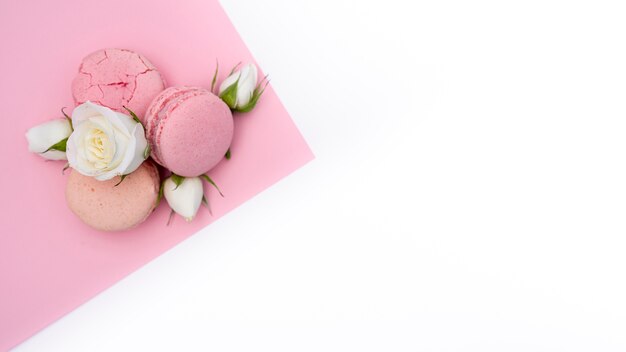 Flat lay of macarons and roses with copy space