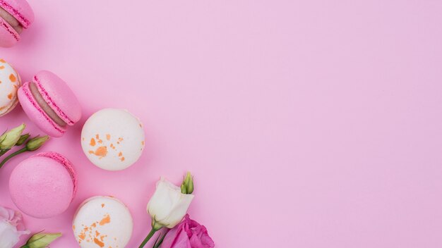 Flat lay of macarons with roses and copy space