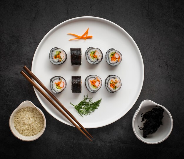 Flat lay maki sushi with chopsticks