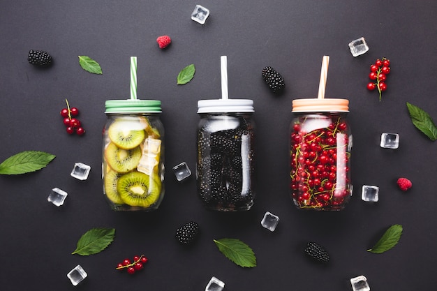 Flat-lay mason jars with berries and kiwi