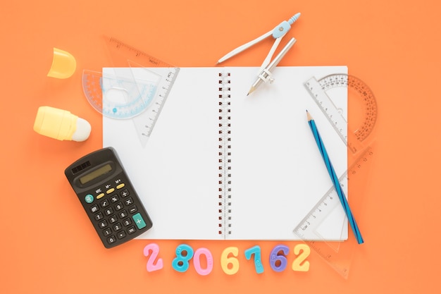 Free photo flat lay math and science calculator with notebook