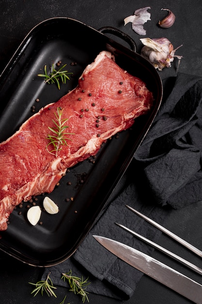 Flat lay meat in plate with cutlery