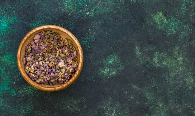 Flat lay of medicinal herbs in bowl with copy space