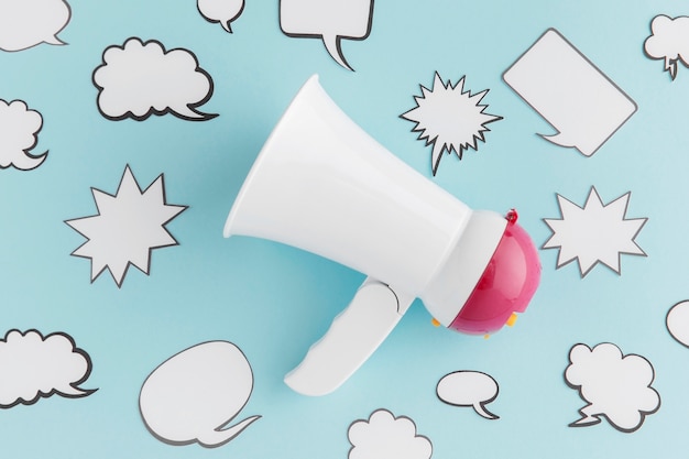 Free photo flat lay of megaphone with chat bubbles