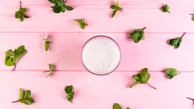 Flat lay milkshake on a pink wooden table