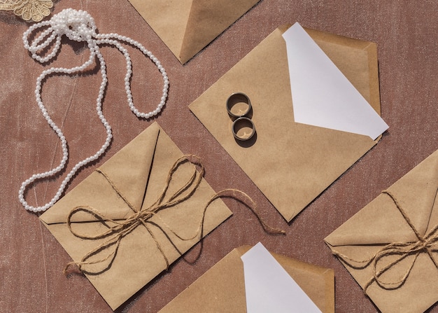 Free photo flat lay minimalist wedding arrangement with opened envelopes