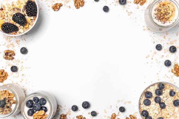 Free photo flat lay mix of yogurt and fruits with oats and copy-space