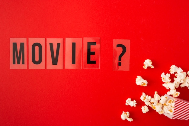 Free photo flat lay movie lettering on red background
