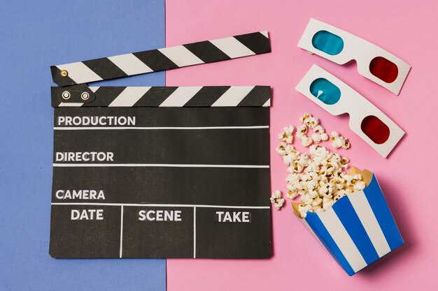 Flat lay movie slate and 3d glasses on table