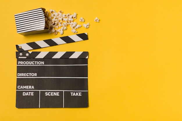 Flat lay movie slate with popcorn