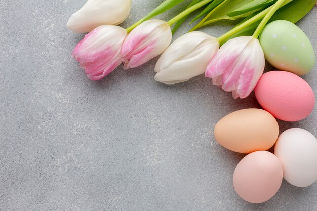 Flat lay of multicolored easter eggs and tulips