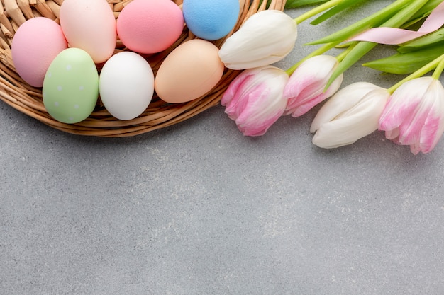 Flat lay of multicolored tulips and easter eggs