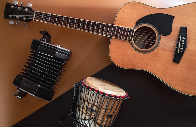 Flat lay music background with acoustic guitar and drum