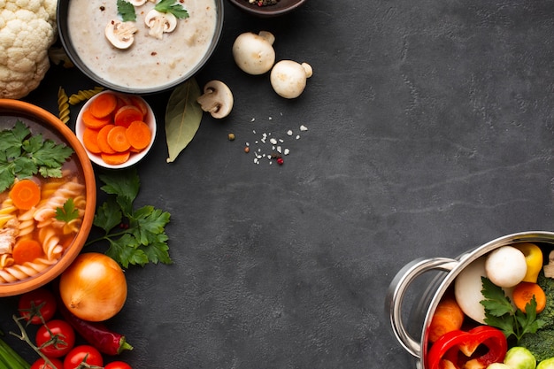 Flat lay musroom bisque vegetable soup with fusilli and vegetables in pan with copy spacecopy space