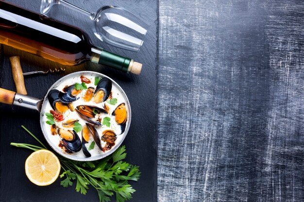 Flat-lay mussels in white sauce and wine with copyspace