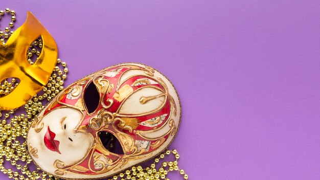 Flat lay mystery carnival golden and elegant masks