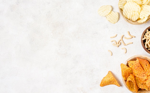 Flat lay of nacho chips and potato chips with copy space