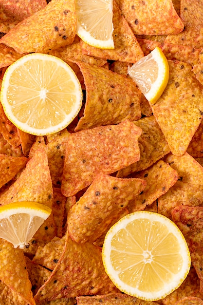 Flat lay of nacho chips with lemon